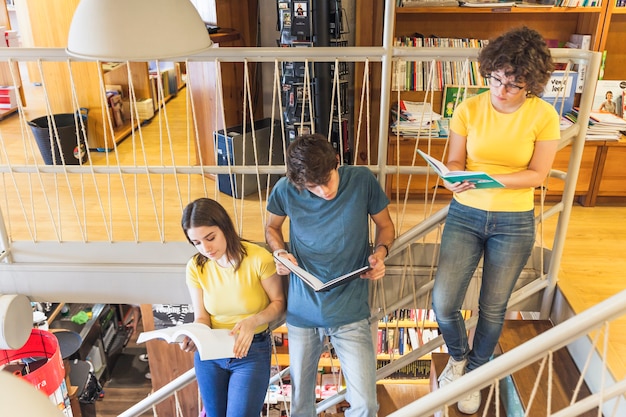 A diverse group of teachers collaborating in a brightly lit school hallway, discussing student progress and strategies. The image represents the collaborative spirit and varied roles within the teaching profession.