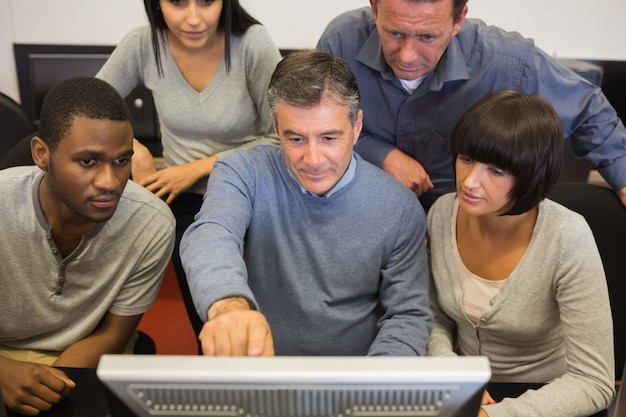 A group of instructors participating in a professional development workshop, learning new techniques and technologies related to vocational training.