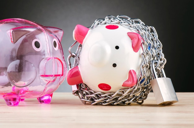 A piggy bank with a bandage on it, symbolizing the importance of having an emergency fund for unexpected financial situations. Coins and dollar bills are scattered around the piggy bank.