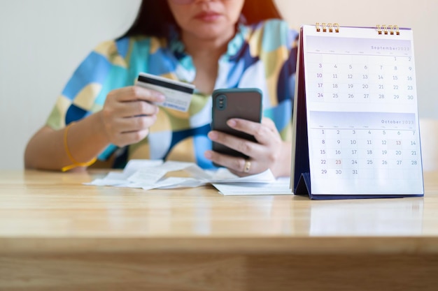 A calendar with due dates marked for various bills and credit card payments, symbolizing timely payment management.