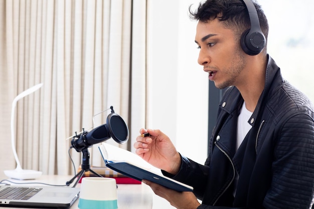 A person recording an online course with professional equipment, including a microphone, camera, and lighting, to demonstrate the production quality expected for successful courses.
