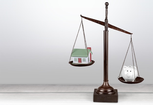 A balanced scale, with a will on one side and a trust on the other, symbolizing the decision-making process involved in estate planning. The background is a blurred image of a law office.