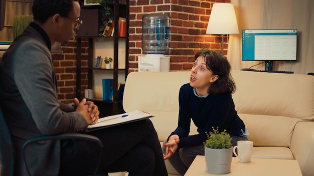 A therapist in a professional setting consulting with an employee. The scene conveys trust, support and confidentiality.