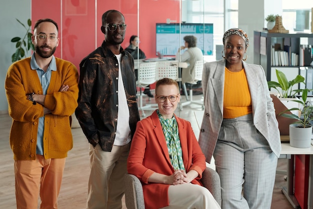 A diverse group of employees in a modern office setting, with a background graphic showing a checklist and the text 