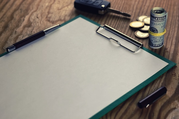 A close-up of an insurance policy document with a pen resting on top. The document highlights key sections dealing with income replacement percentages.