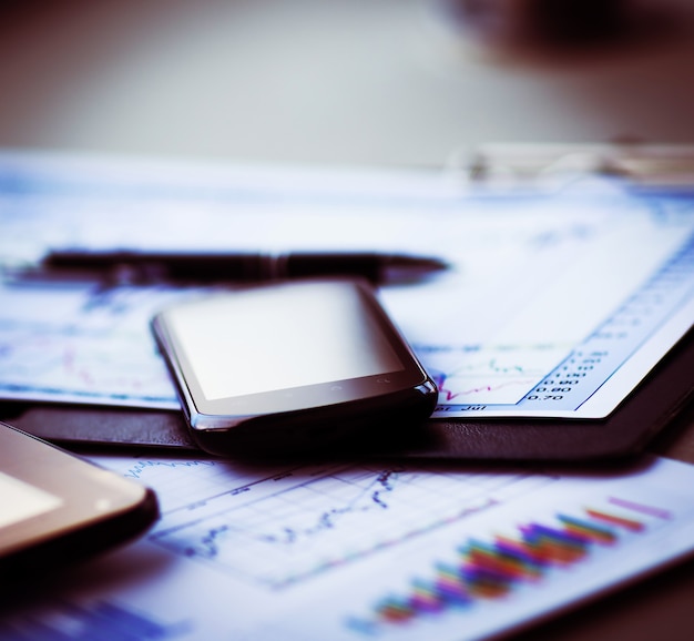 A close-up shot of a calculator and financial documents related to stock options or employee benefits, emphasizing the importance of financial planning and understanding the terms of an ESPP.