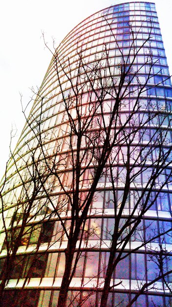 A split image showing a thriving company headquarters on one side and a downturned graph on the other, symbolizing the potential upsides and downsides of investing in company stock through an ESPP.