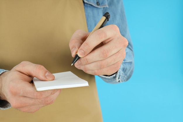 A close-up shot of a person reviewing an employee benefits package, with a pen circling the section on life insurance. The focus is on the detail and complexity of understanding the insurance options offered by an employer, with an emphasis on the fine print.