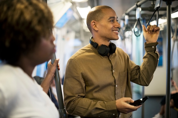 A group of diverse professionals chatting and laughing inside a modern, clean-looking commuter train, emphasizing the social and environmentally friendly aspects of using public transportation.