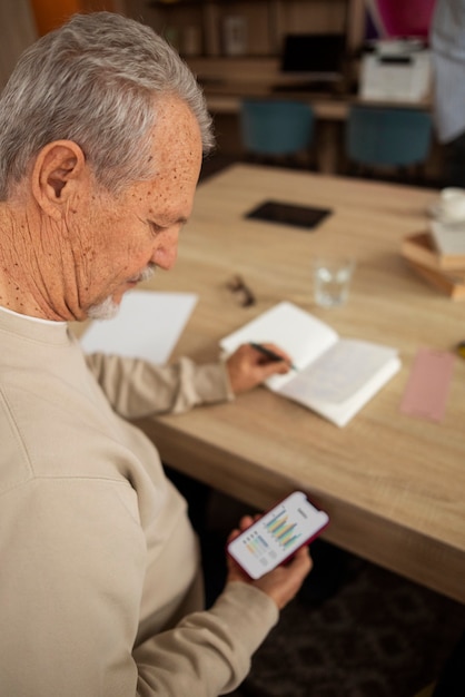 A person using a retirement planning calculator app on their smartphone, with graphs and charts indicating projected savings growth over time, emphasizing how contribution adjustments can make a difference.