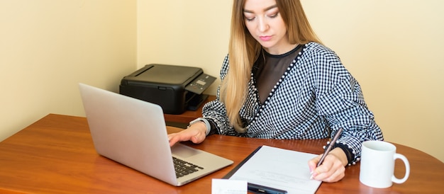 An image showing a student using a laptop to fill out the FAFSA form, with a notebook and pen beside them, emphasizing the importance of accurate and timely application for federal aid while focusing on deadlines and required data
