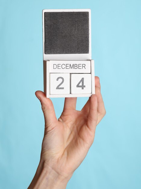 A close-up of a calendar with several dates circled, representing timely bill payments. A hand is shown checking off a payment on a list.