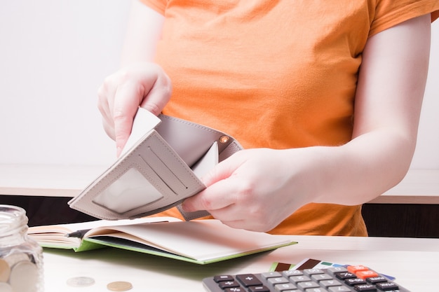 A person crossing items off a budget checklist, showing progress and achievement in their financial planning.