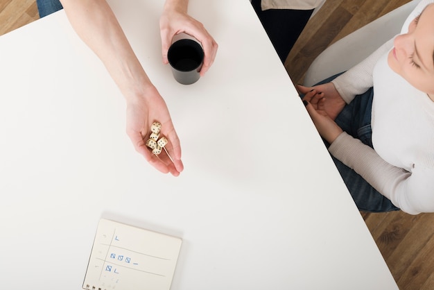 An image of two hands reaching towards each other over a table covered with financial documents, symbolizing negotiation and agreement on financial matters during divorce, with a warm, collaborative tone.