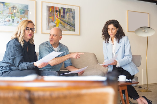 A lawyer sitting at a desk, meeting with a blended family, discussing estate planning documents. The atmosphere is professional and supportive.