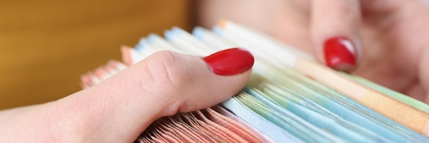 A close-up shot of hands organizing various financial documents on a table, including bank statements, tax returns, and investment reports. The focus is on the meticulous arrangement and attention to detail.