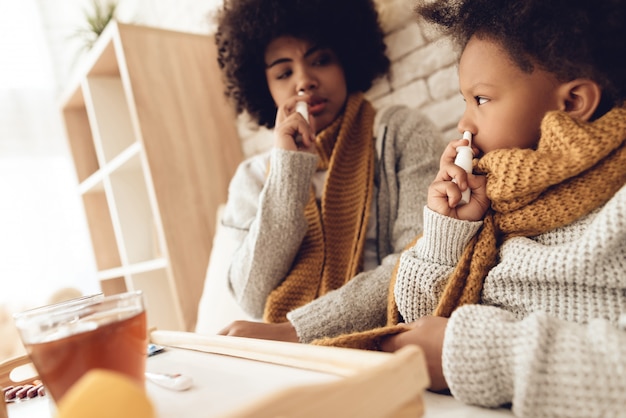 A medium shot of a parent sitting at a table with their child, helping with homework. The child looks engaged and focused. The background is a warm, inviting living room with bookshelves and family photos. The overall impression is one of support, encouragement, and positive parent-child interaction.