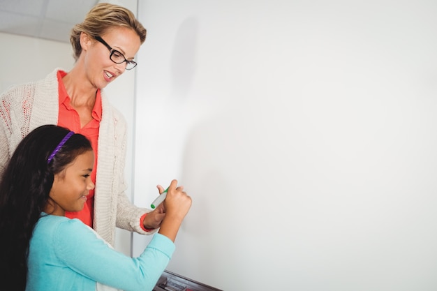 A close-up image of a teacher helping a student with their work, highlighting the direct impact of federal education policies on classroom interactions. The image should convey a sense of dedication and student-teacher collaboration.
