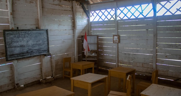 An empty classroom with desks neatly arranged, but no students or teacher present, symbolizing the teacher shortage and the lack of educators in certain areas.