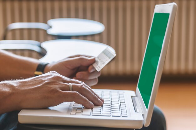 A laptop displaying the website of a prominent online bank, showing the high-yield savings account rates prominently. A hand is hovering over the mouse, ready to click and open an account.