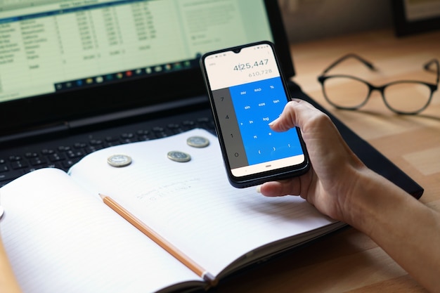A smartphone displaying a balance transfer offer on a credit card app. The background features financial graphs and charts, emphasizing the financial benefits.
