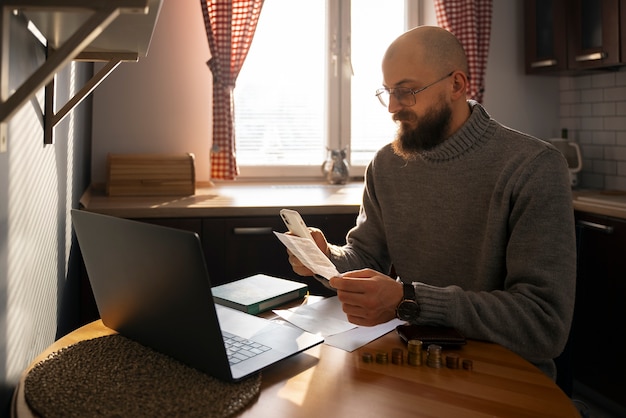 A person working on a laptop at home, reviewing financial documents and adjusting contribution settings online. Focus on a cozy, productive home environment.
