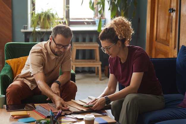 A diverse group of people sitting in a classroom, listening attentively to an instructor. The scene depicts a homebuyer education course, with participants taking notes and engaging with the material.