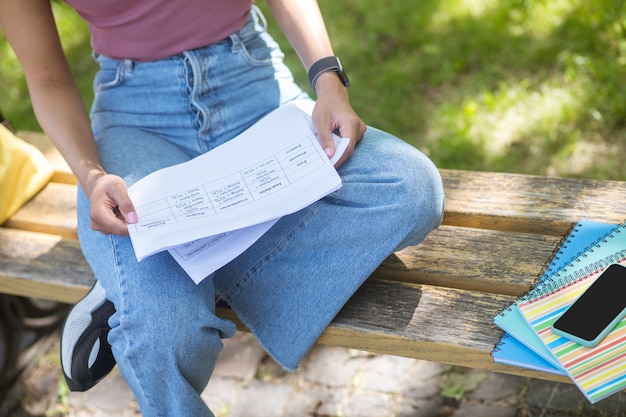 A close-up shot of a student loan bill with various interest rates and repayment options highlighted. A calculator and pen are nearby, symbolizing the need for careful calculation and decision-making in loan management.