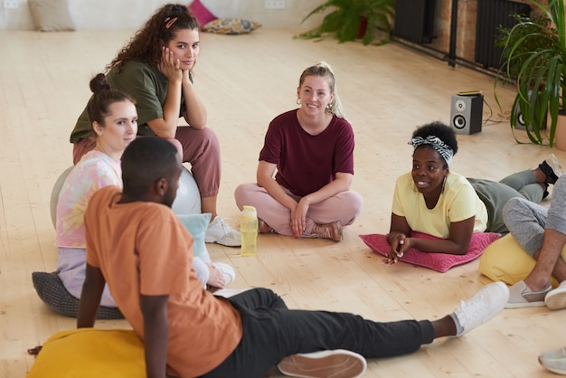 A diverse group of employees participating in a wellness program activity, such as a yoga class or a health screening event. The scene is vibrant and promotes a culture of well-being.
