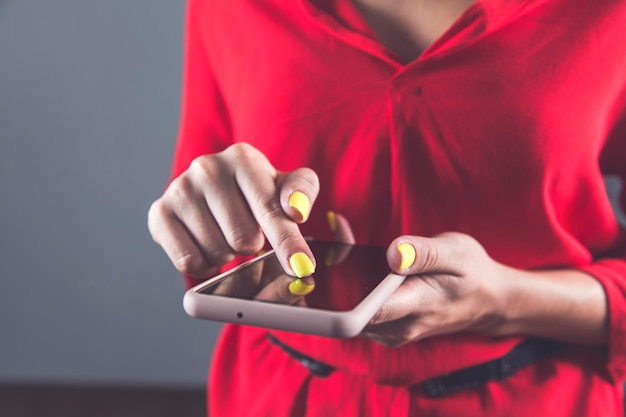 A person using a budgeting app on their smartphone, alongside images of coins and dollar bills, representing effective financial planning for HSA contributions. The color scheme is calm and professional, focusing on fiscal responsibility.