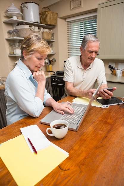 A financial advisor meeting with a couple in their home office, reviewing a comprehensive retirement plan document. The scene is professional and reassuring, symbolizing informed decision-making and long-term financial planning.