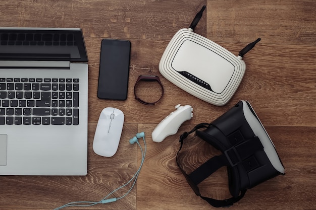 A high-speed internet router and various tech gadgets such as noise-canceling headphones and a high-resolution webcam, representing essential tools for remote work productivity.