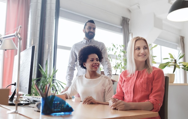 A diverse group of employees in a modern office setting, gathered around a table for a benefits presentation. The presenter is pointing to a slide about long-term care insurance, while the employees are engaged and asking questions. The scene should highlight the importance of understanding and utilizing employee benefits for long-term security.