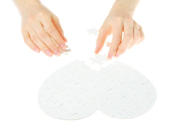 A serene image of a hand gently placing a puzzle piece into a completed puzzle, symbolizing the holistic planning and security provided by long-term care insurance as part of comprehensive employee benefits. The background should convey a sense of calmness and assurance in preparing for the future.