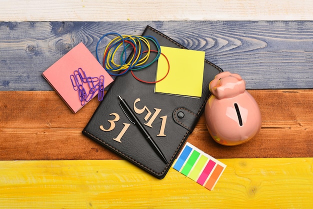 A close-up of a handwritten budget on a notepad, with various income and expense categories clearly labeled. A pen is resting on the notepad, and a calculator is nearby. The scene conveys careful financial planning.