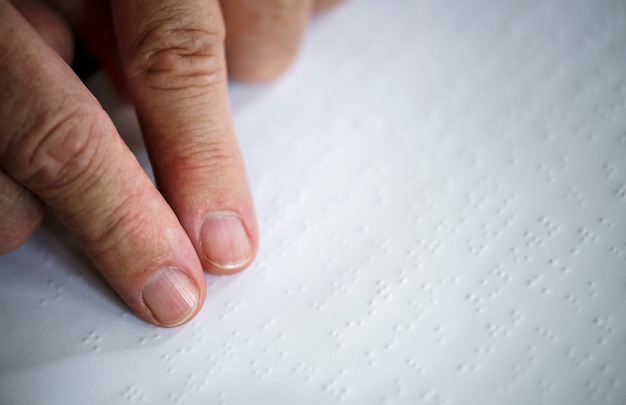 A close-up shot of a standardized test form with bubbles to be filled in. A hand is shown filling in one of the bubbles with a pencil.