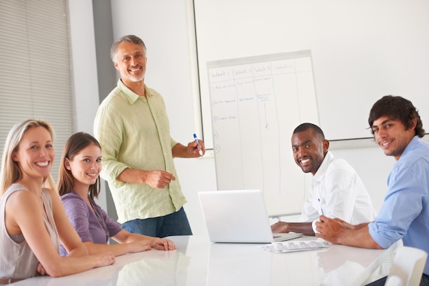 A group of new teachers participating in a professional development workshop, learning about effective teaching strategies and classroom management techniques. The facilitator is leading an interactive session.