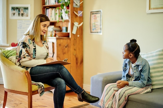 A school counselor talking to a student in a comfortable and private setting. The image emphasizes the importance of mental health support in schools and the role of counselors in providing guidance and assistance.