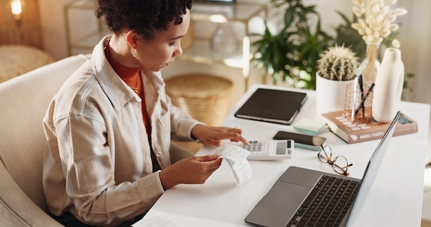 A person carefully managing their credit cards and bills, using a laptop and a budget planner, set in a clean and organized home office environment.